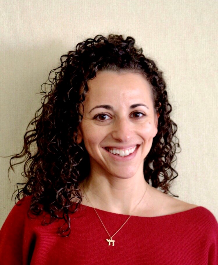 Headshot of Rachel Hall wearing a red top 