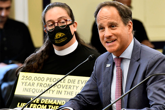 Rabbi Jonah Pesner sits giving a testimony before members of Congress.